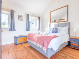 The bedroom has a king size bed.