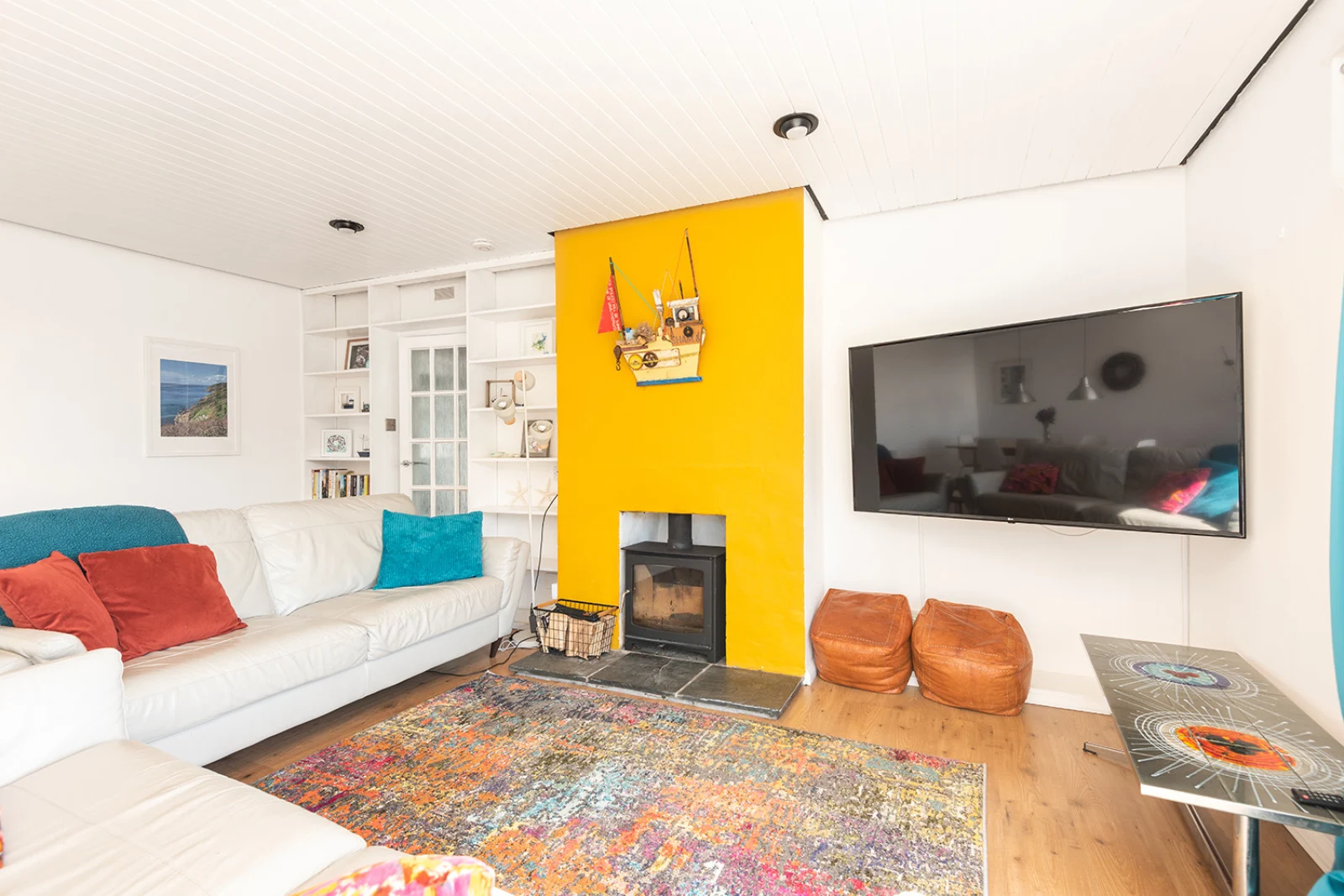 Comfortable lounge with huge TV and woodburner