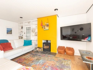 Comfortable lounge with huge TV and woodburner