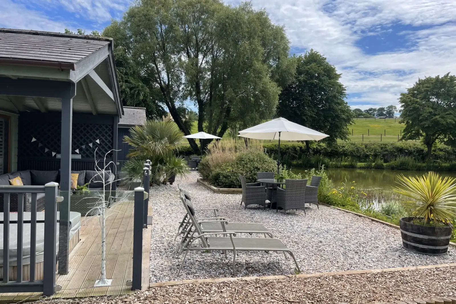 Private balcony to the front of the lodge with table, chairs and hot tub -  Kingfisher Lodge