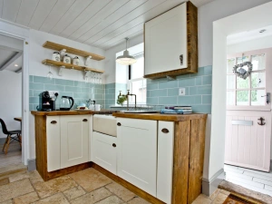 Kitchen with coffee machine, kettle, and Belfast sink - Birdcage Cottage