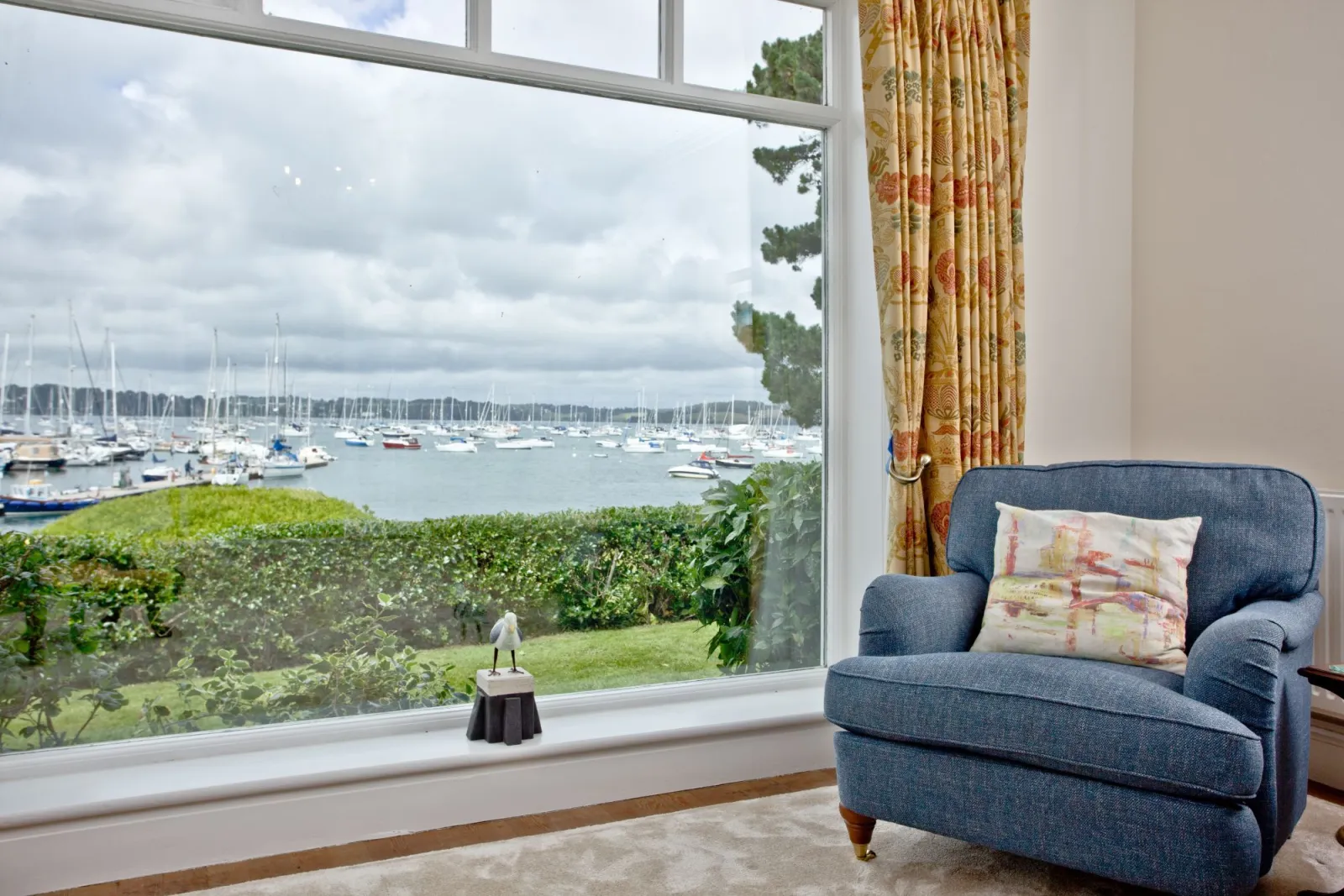 Living room with large window and river view - Cregoes