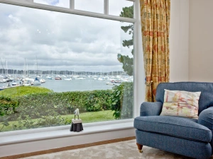 Living room with large window and river view - Cregoes