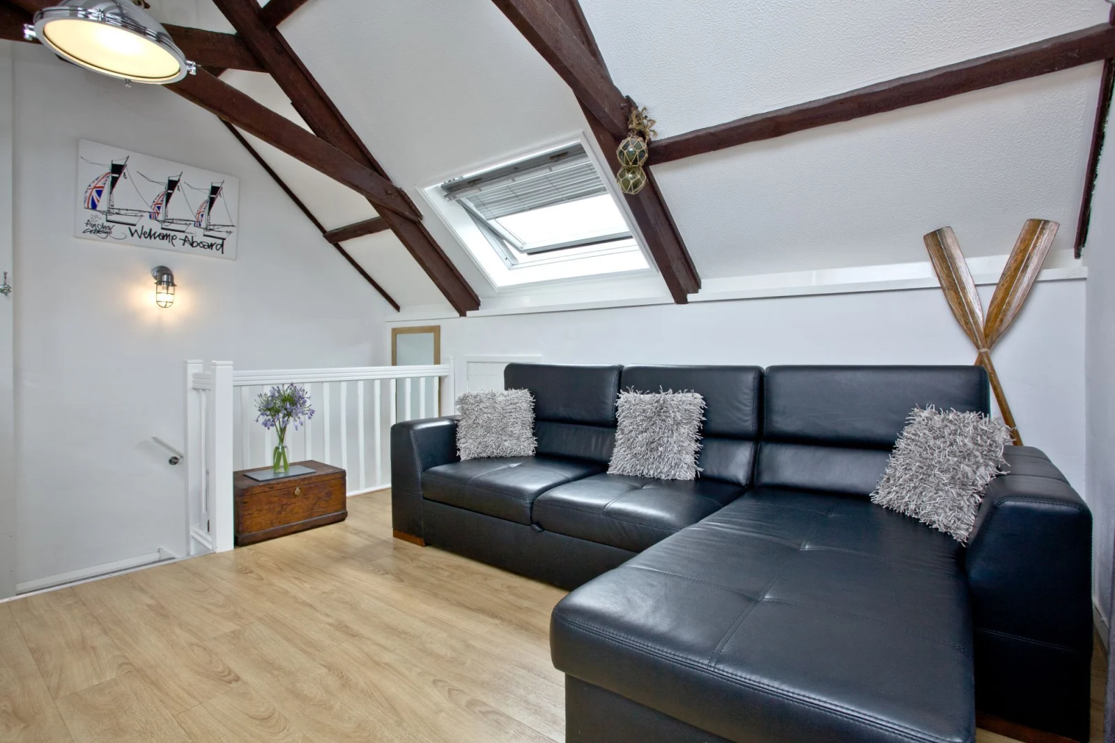 The sofa bed with seating for all guests and scatter cushions - Anchor Cottage 
