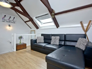 The sofa bed with seating for all guests and scatter cushions - Anchor Cottage 