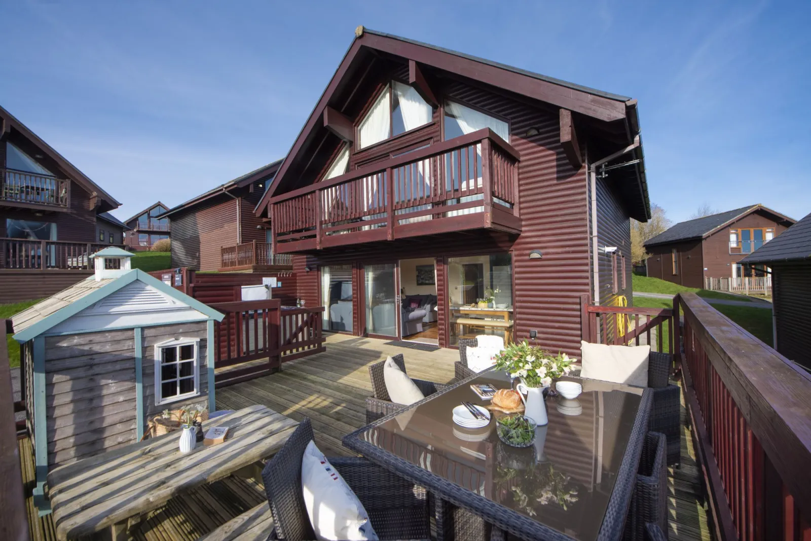 Front of lodge with outdoor seating and decking - Lodge 40, Retallack