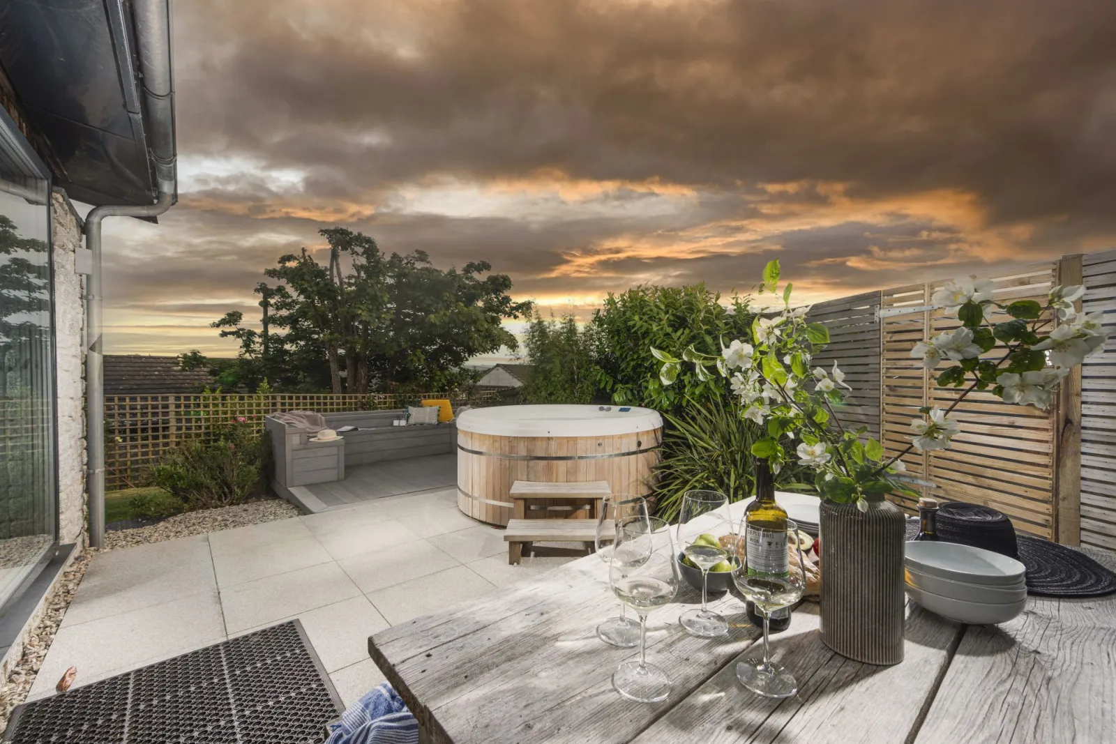 Dusk shot of the patio and hot tub - 6 The Dunes, Upton Towans