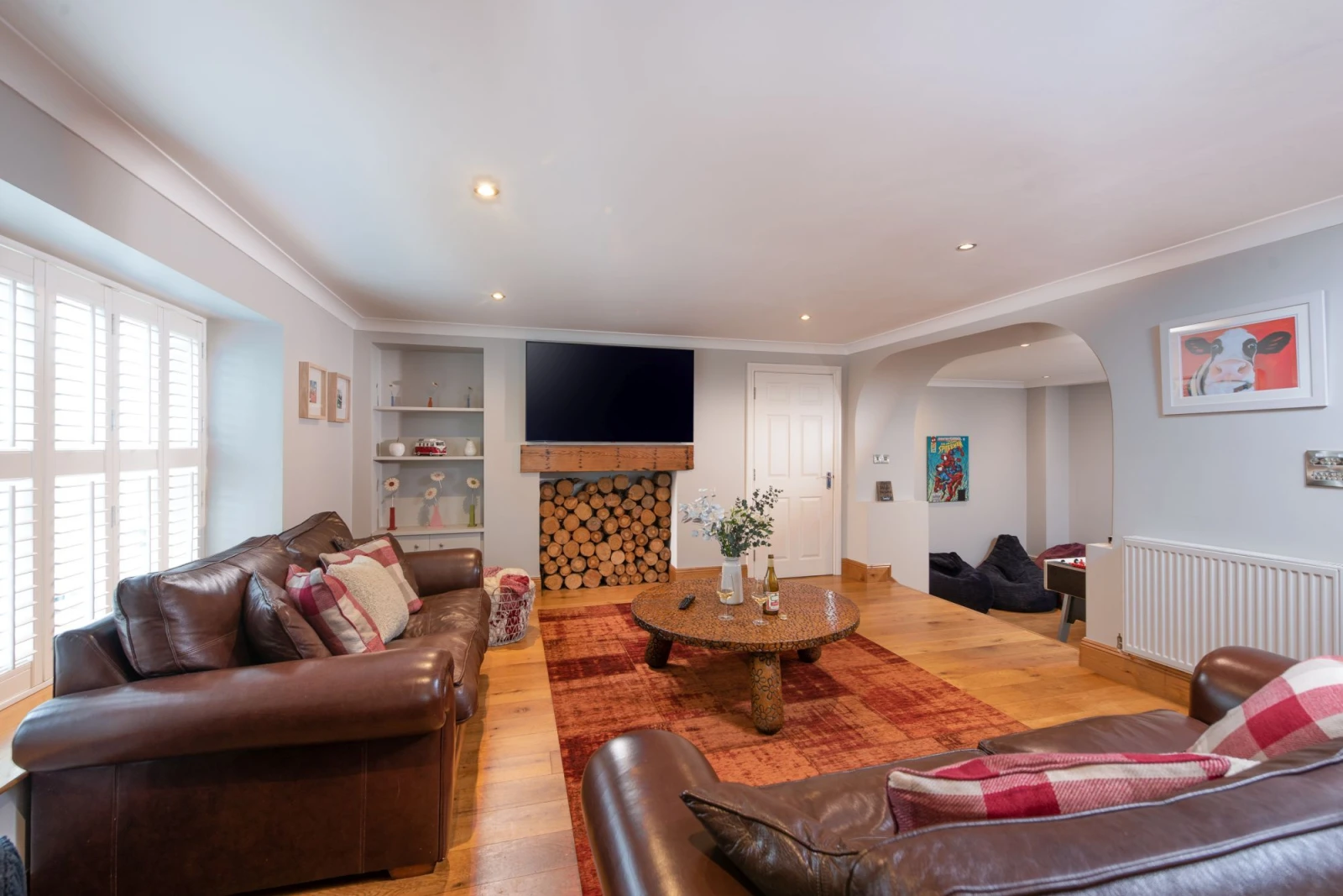 Living area, smart TV, large coffee table and stairs leading down to the games room - 3 The Manor, Porthkidney Sands