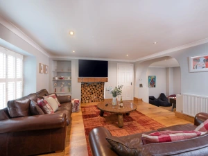 Living area, smart TV, large coffee table and stairs leading down to the games room - 3 The Manor, Porthkidney Sands
