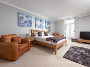 Spacious master suite with armchairs, TV and  access onto the patio - 3 The Manor, Porthkidney Sands