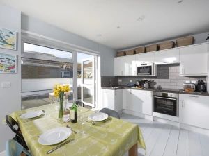 Dining and kitchen area leading to balcony - Mousehole View