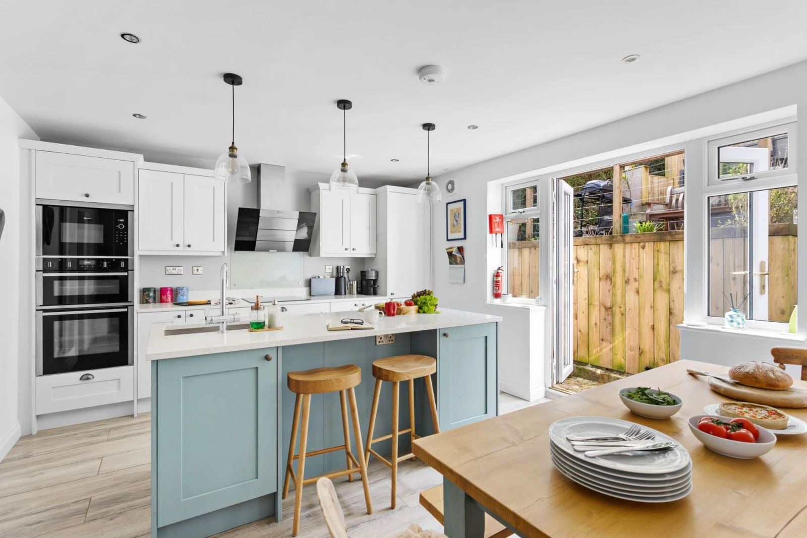 Open plan kitchen/dining room with island seating for two and access onto the back garden  - Bumble Cottage
