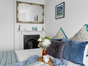 Bedroom 2 with double bed, soft furnishings and ornamental fireplace - Bumble Cottage
