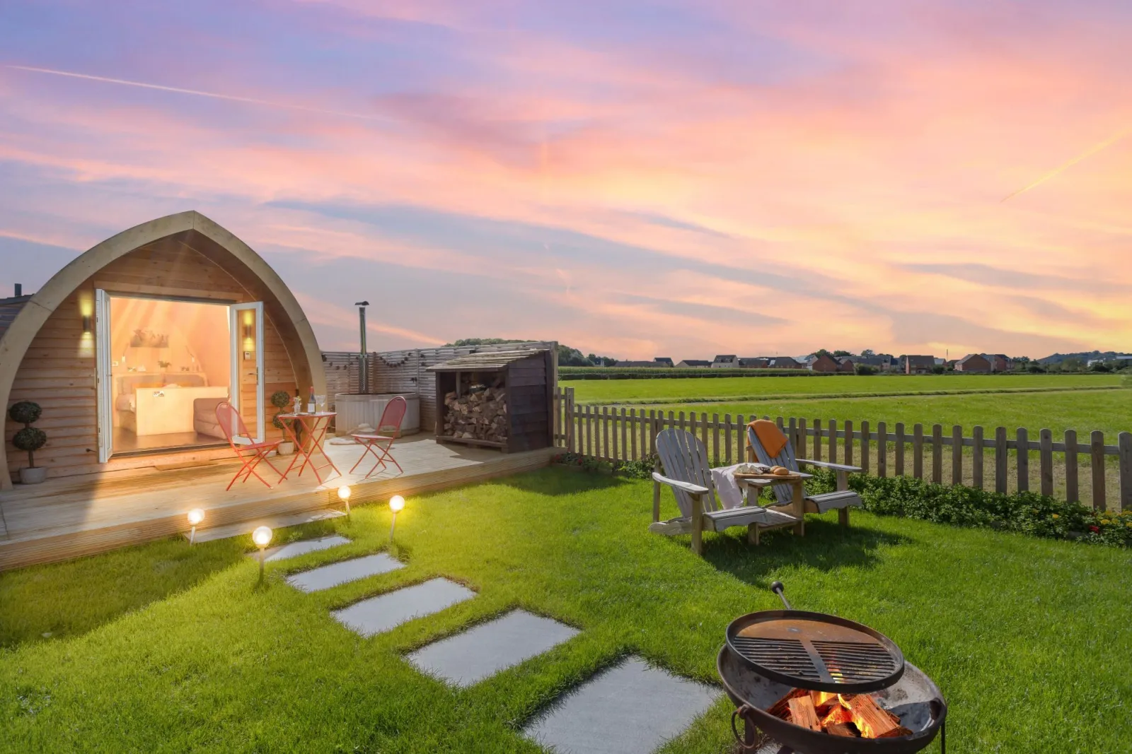 The garden at Chapterhouse with a firepit, seating and a hot tub - Chapterhouse 