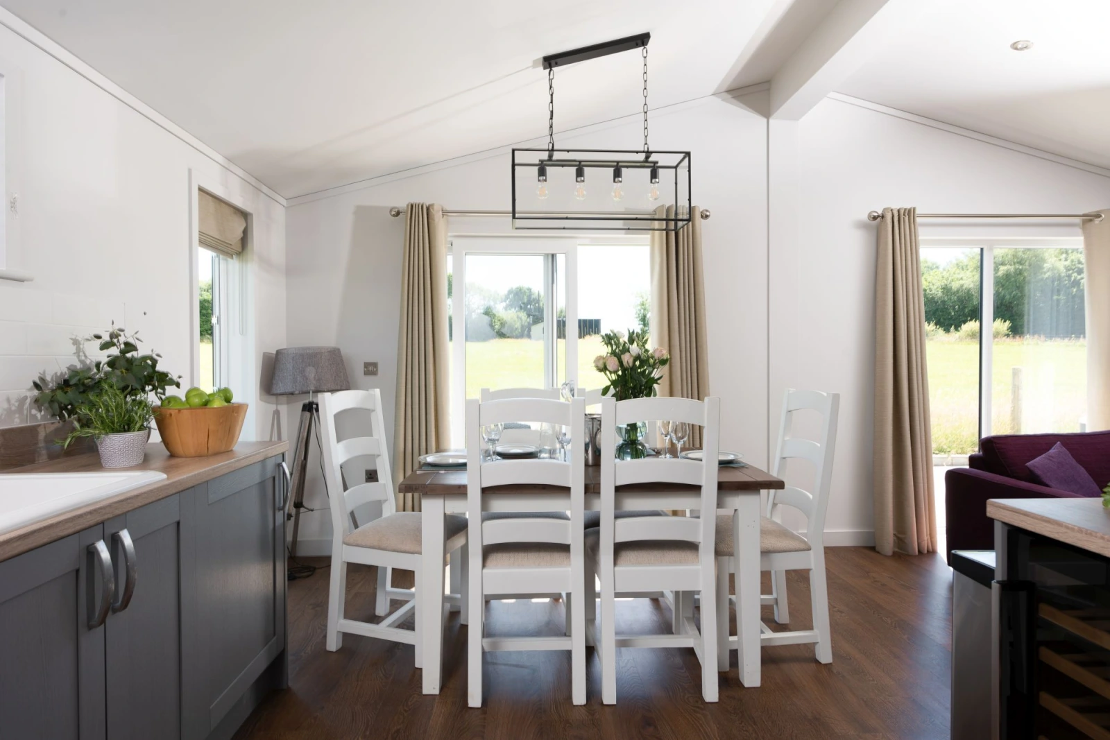 A dining table and chairs for all guests to eat together or play games - Forget Me Not Lodge 