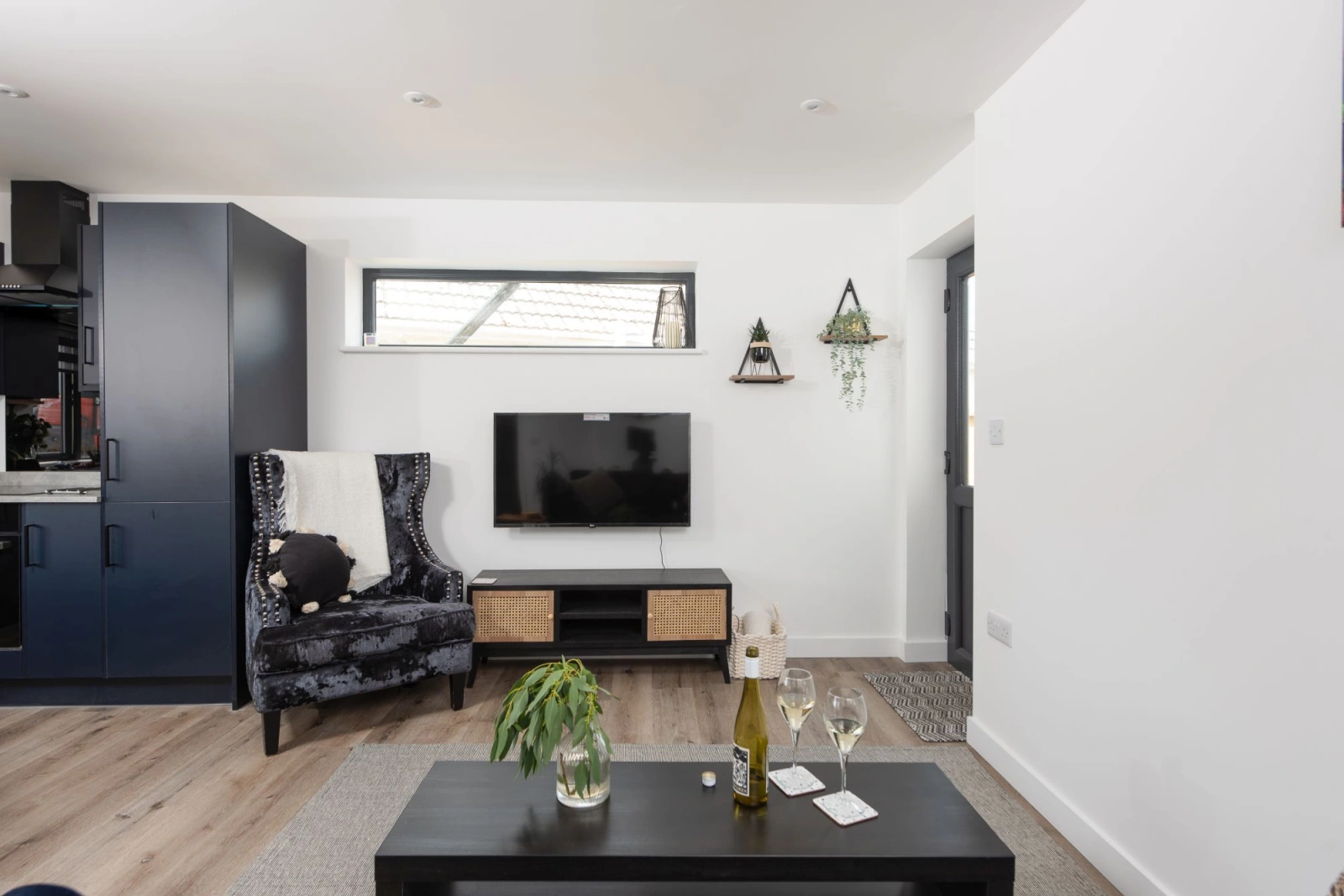 Lounge, coffee table, TV and front door to property - Bay Dream