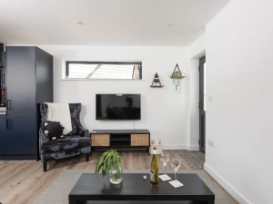 Lounge, coffee table, TV and front door to property - Bay Dream
