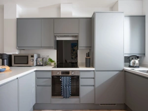 Kitchen fitted with electric oven, induction hob, microwave, toaster, kettle, fridge/freezer, dishwasher, washing machine and Nespresso pod machine - Towans Retreat