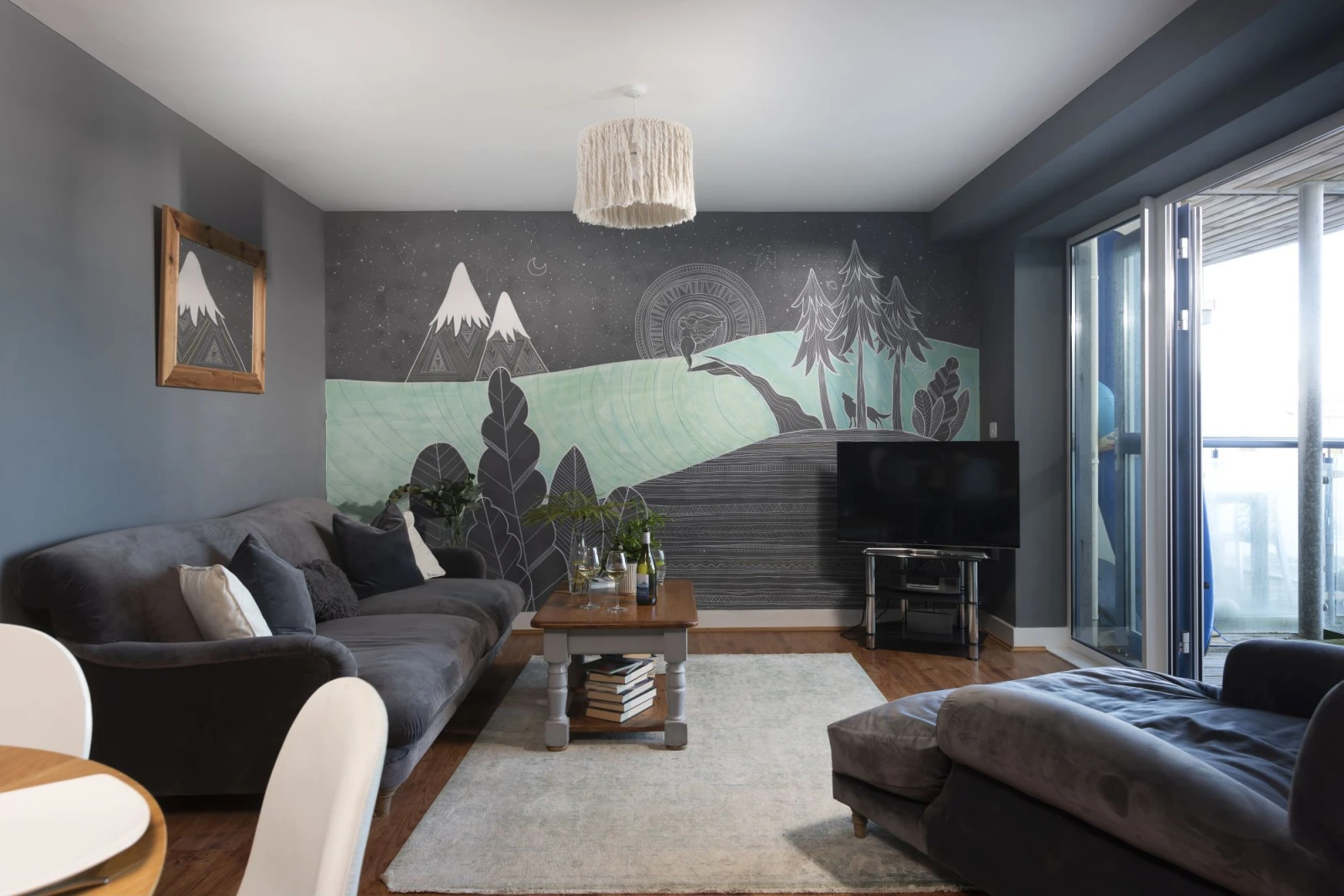 Open living room with hand painted artwork on the wall and Balcony access - Bathsheba, Ocean 1