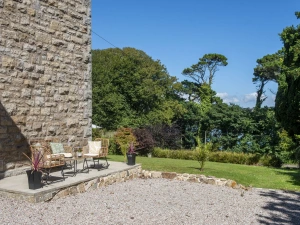 Patio seating area with garden and estuary view - The Elms