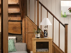 A side table with a lamp and stairs - No.1 St Eia