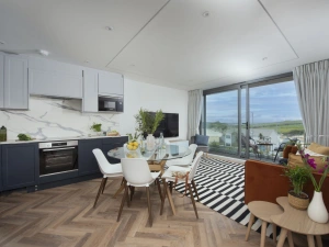 Kitchen and dining area with the sofa and TV seating for 6 - 5 Oasis Sands