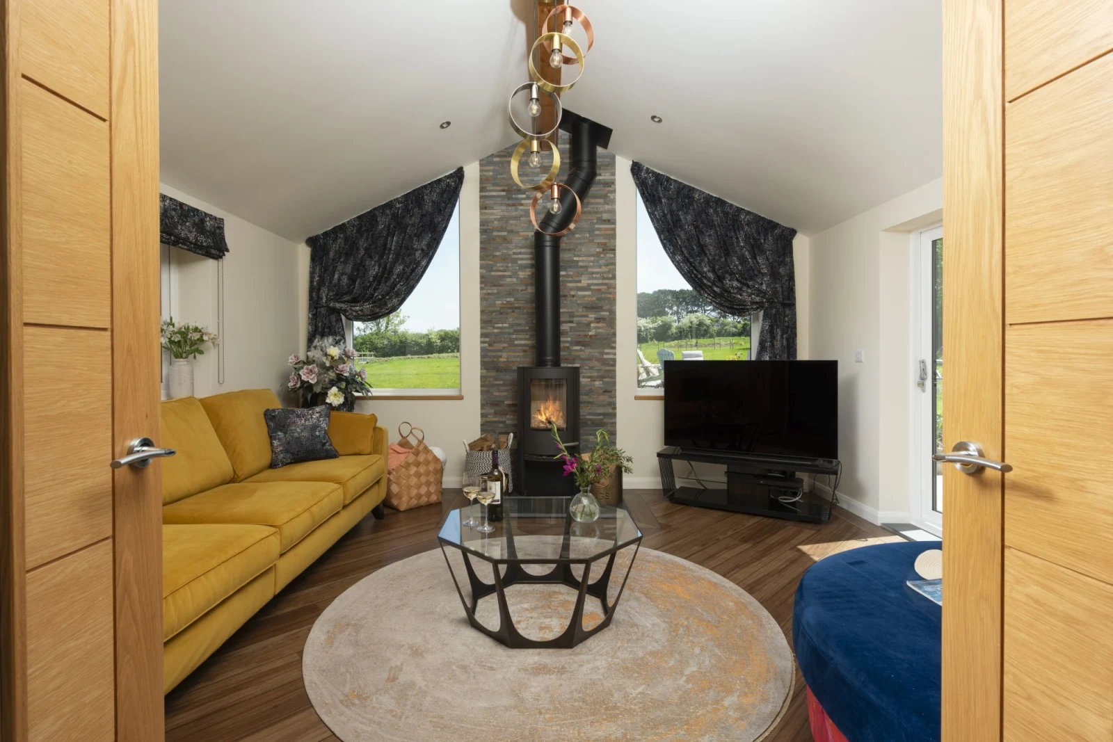 Living area with lots of comfortable seating and wood burner - Highfield Barton