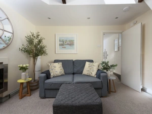 Sofa and foot stool in living room - Bessie Ellen's Cottage