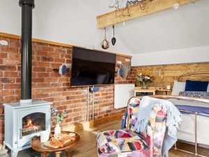 Comfy seating near the fireplace - Porth Chapel