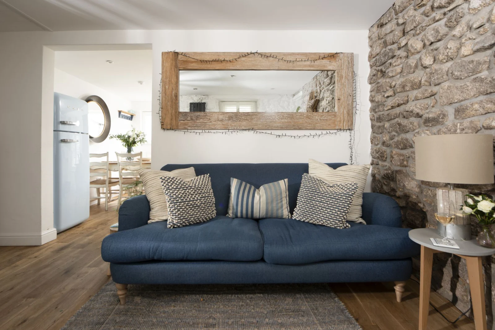 Sofa in living room with access to kitchen and dining room - Happy Days Cottage