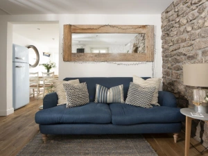 Sofa in living room with access to kitchen and dining room - Happy Days Cottage