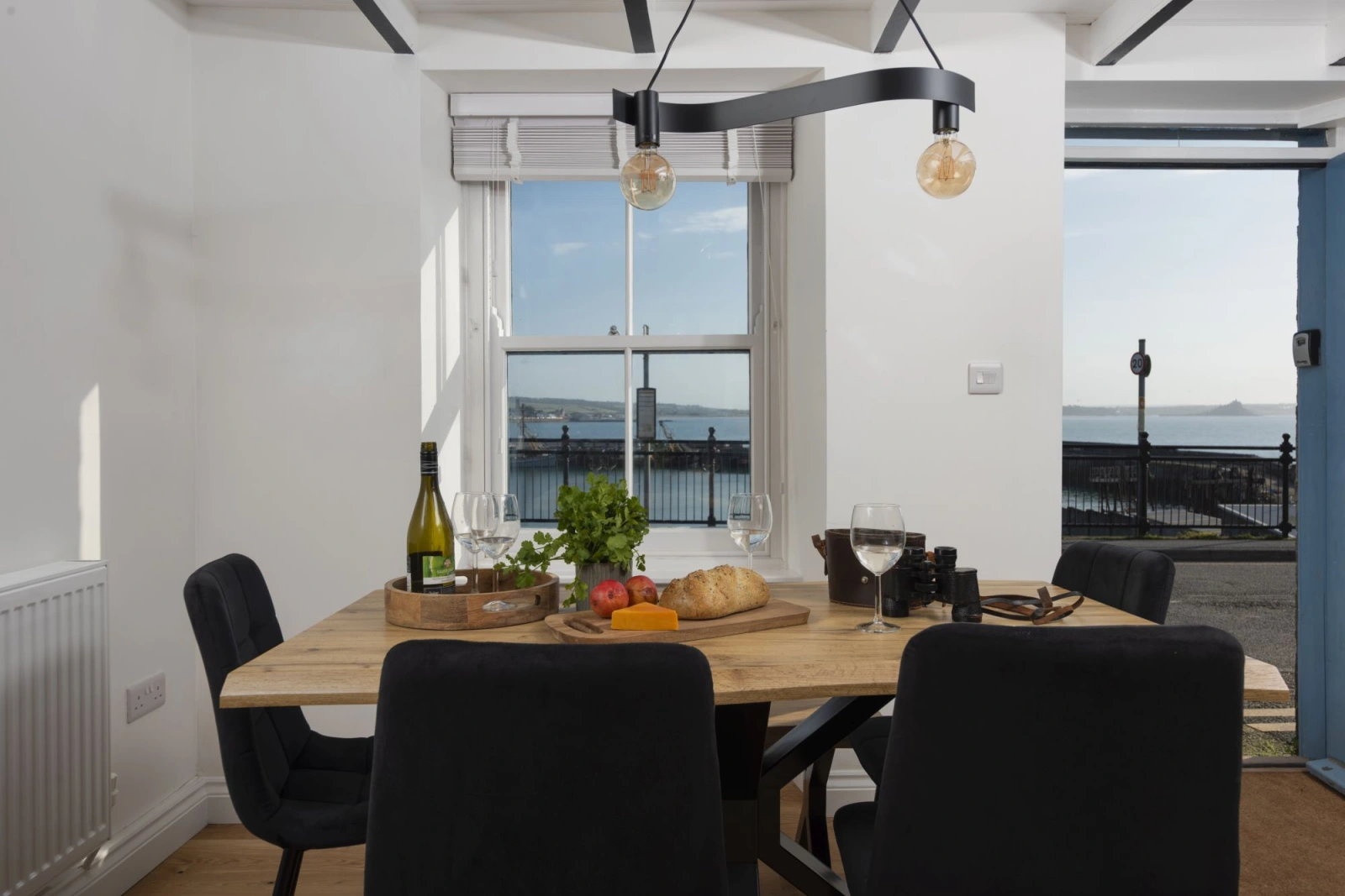 Dining area seating six with harbour views - Harbour Watch Cottage