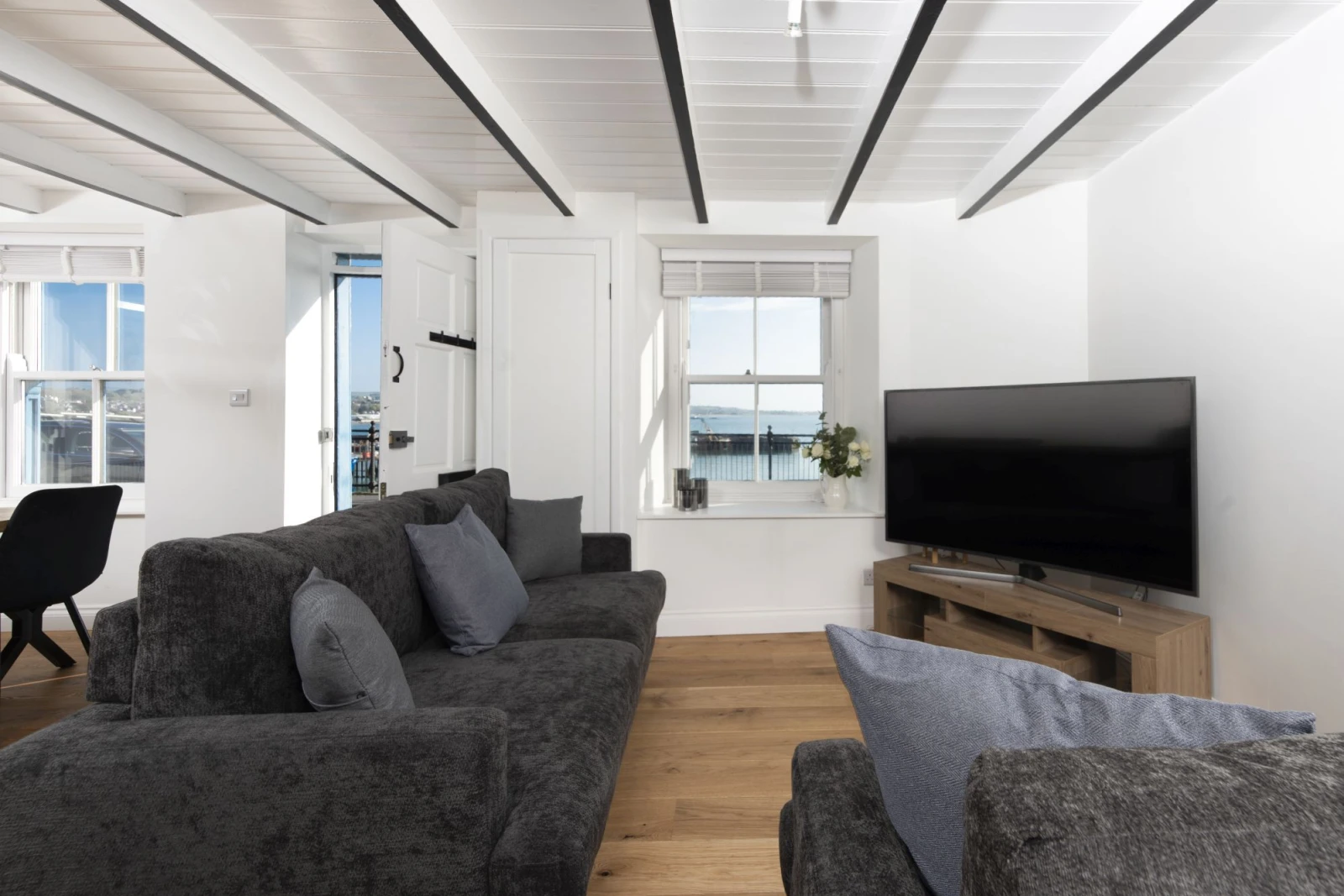 Living area with views over the Harbour - Harbour Watch Cottage