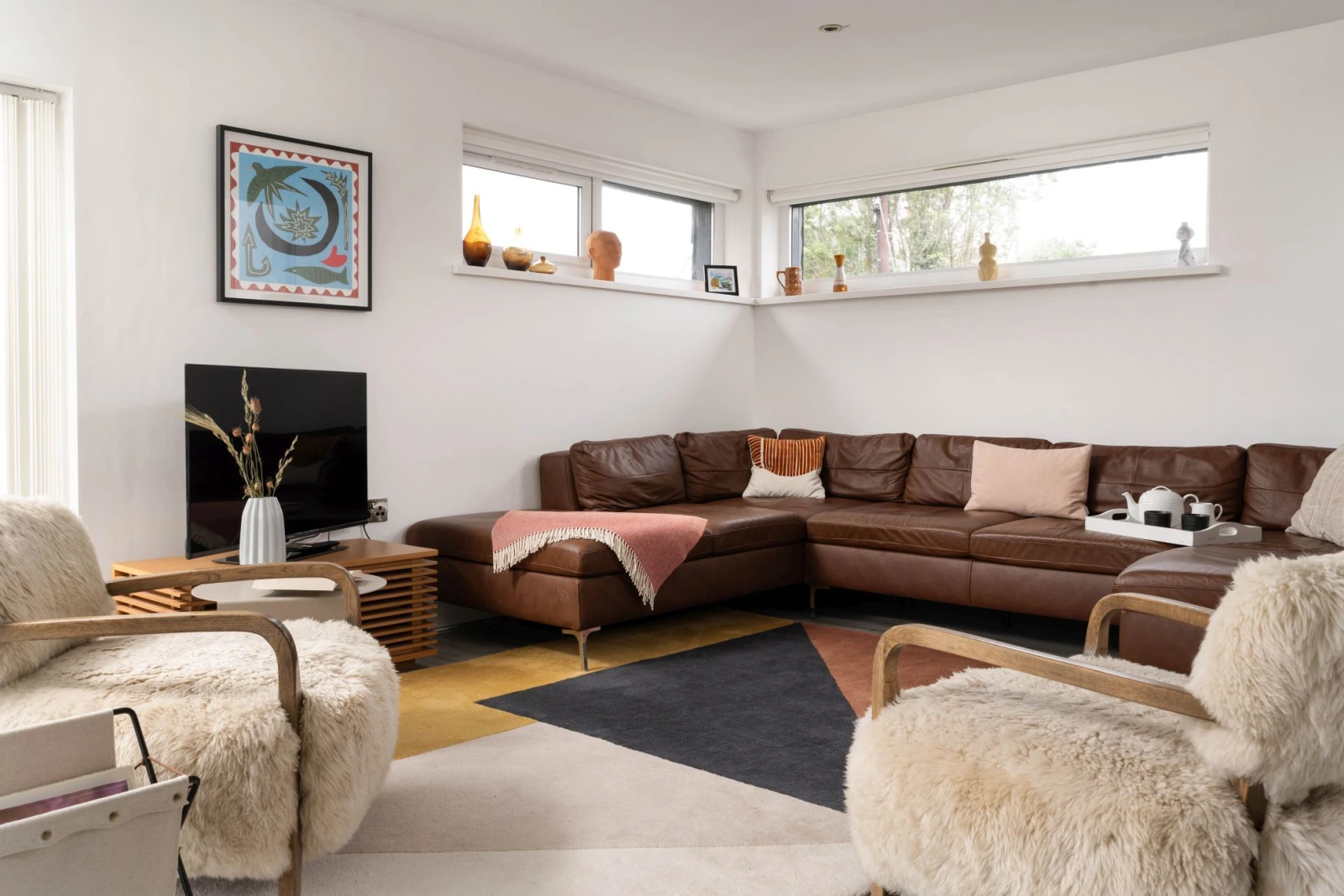 Living space with large leather corner sofa - Estuary Watch