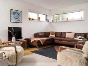 Living space with large leather corner sofa - Estuary Watch