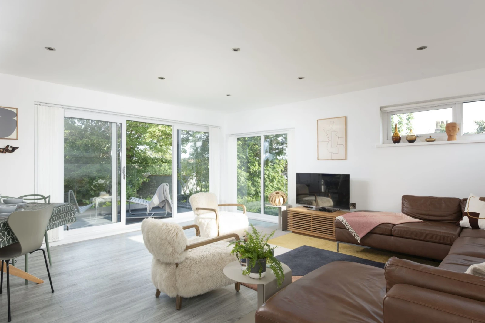 Living area with Smart TV leading to balcony with views - Estuary Watch