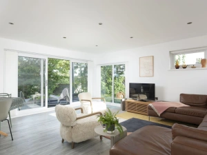 Living area with Smart TV leading to balcony with views - Estuary Watch