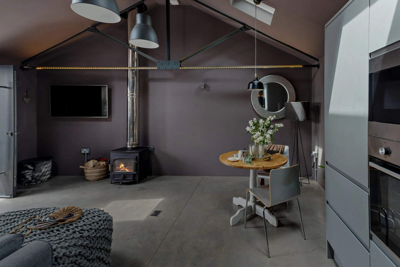 Living and dining space with TV and wood burner - The Beam