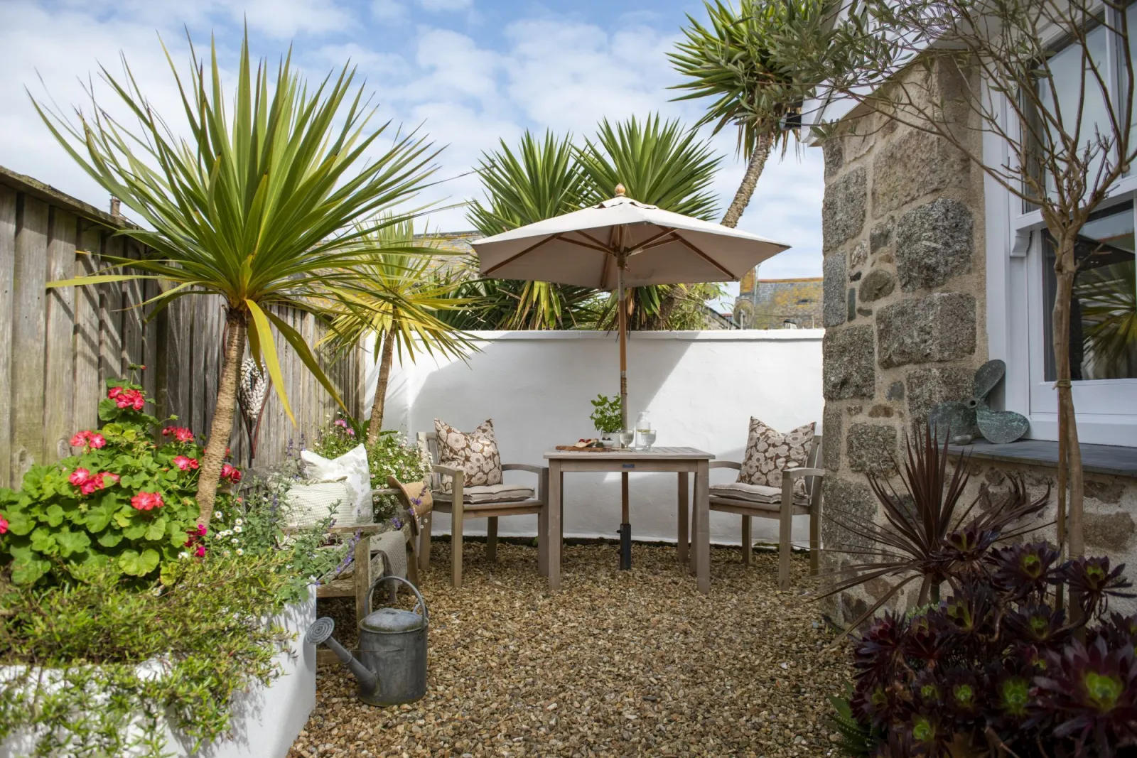 Garden with bistro table and parasol, outdoor dining area - The store Room 