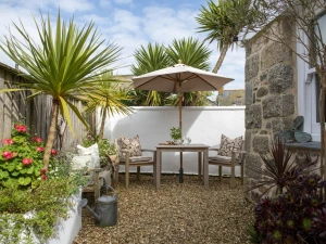 Garden with bistro table and parasol, outdoor dining area - The store Room 