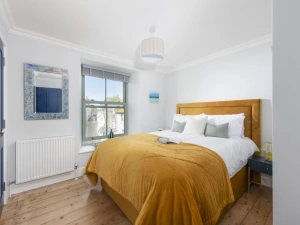 Bedroom with king size bed with side tables, lamps and ensuite - Mermaids 3