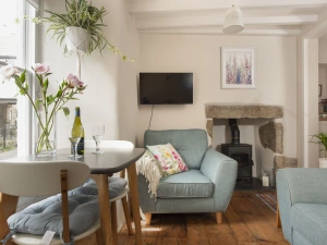 Living and dining area, table for 2 people, sofa's, TV - Berakah