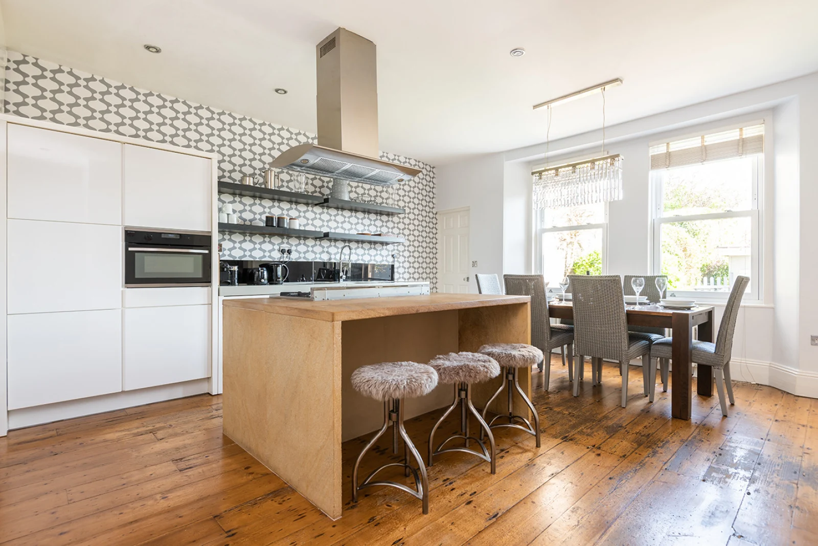 Large fully equipped kitchen with modern appliances, breakfast bar and open plan dining area.