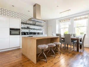 Large fully equipped kitchen with modern appliances, breakfast bar and open plan dining area.