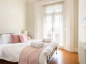 Bedroom 2 with 5ft king bed and patio doors to front terrace.