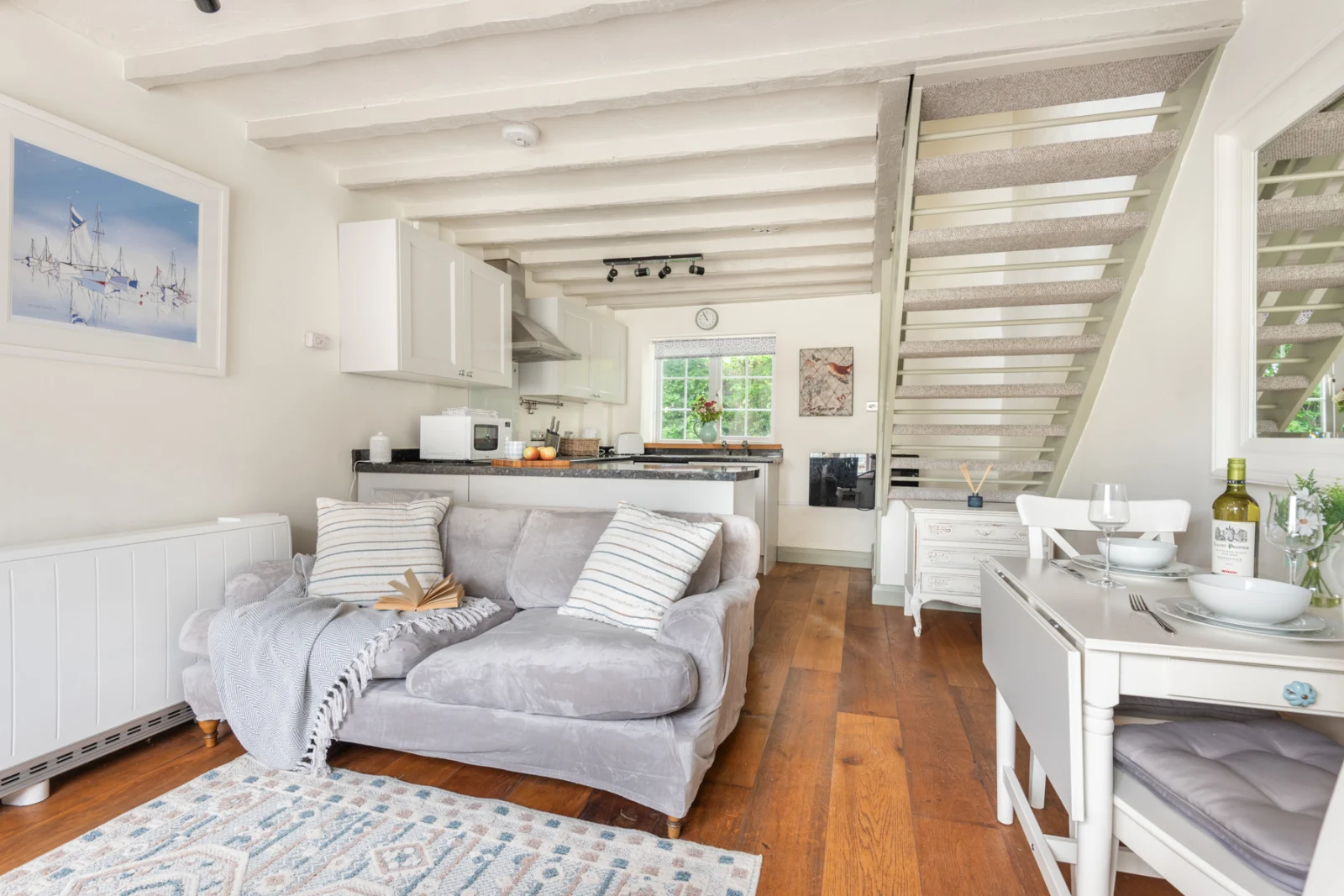 Open plan kitchen, dining set and sitting room. 