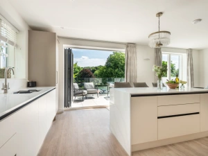 The contemporary kitchen diner leads on to the terrace