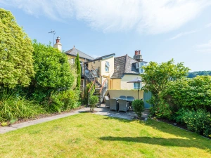 Private lawned garden with paved patio area.