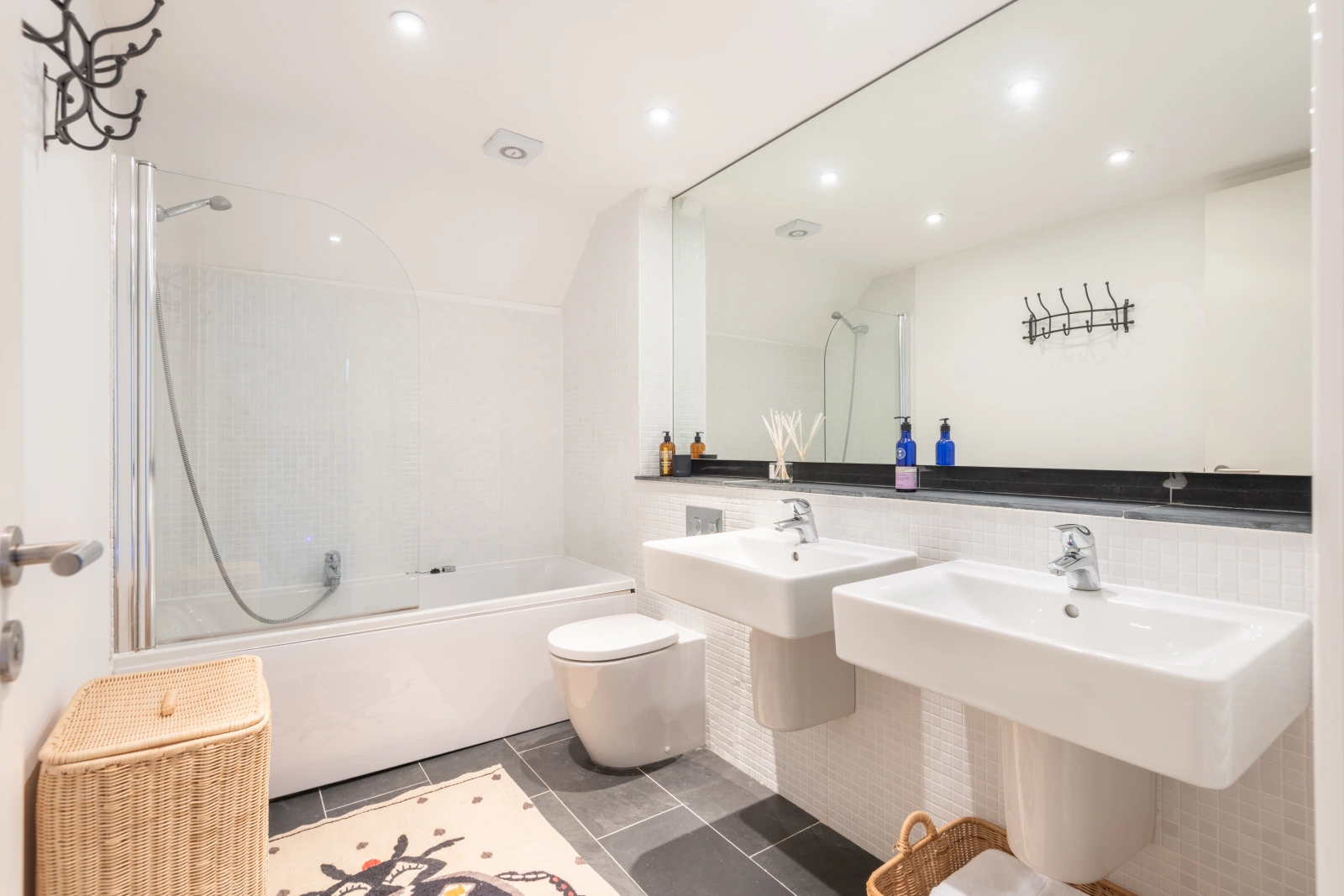 Family bathroom with shower over bath.