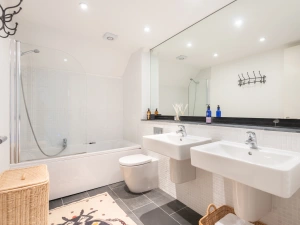 Family bathroom with shower over bath.